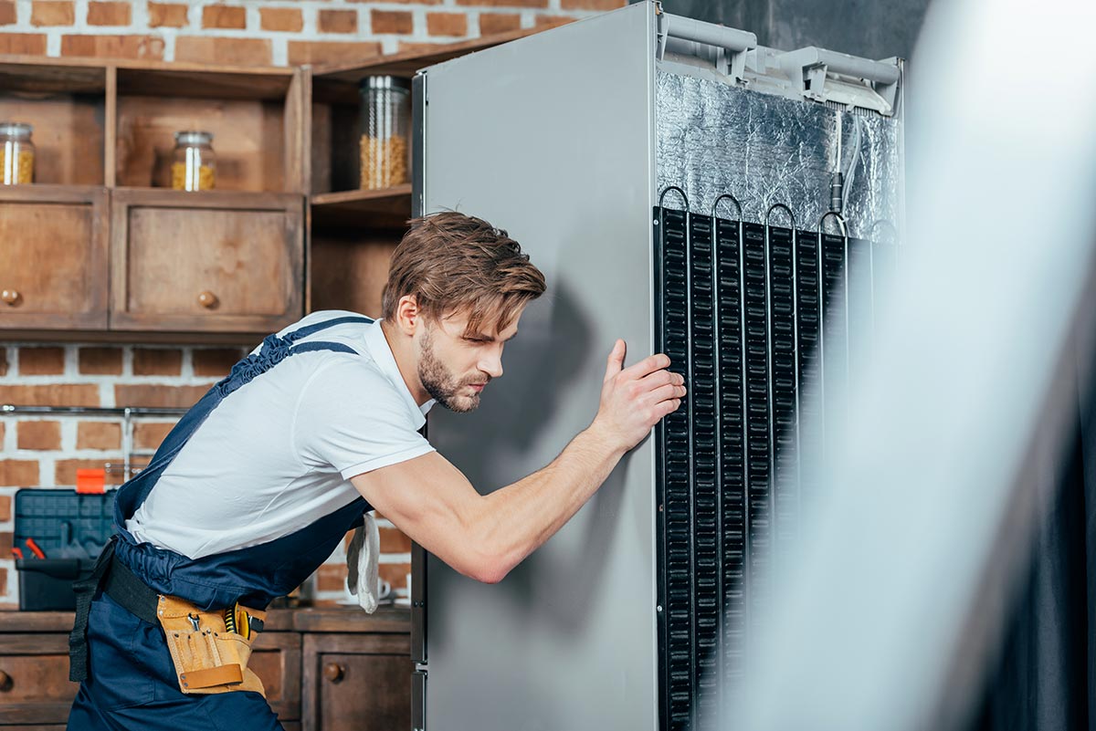 My Appliance Guy technician repairing a refrigerator in an Eastlake home