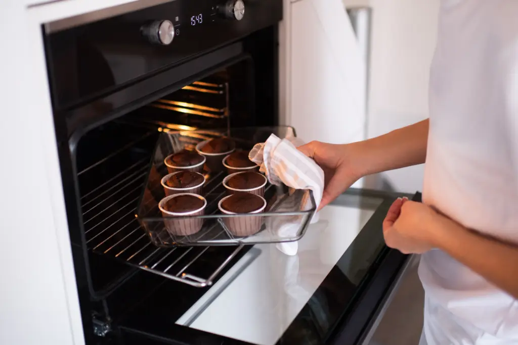 Are Microwave Ovens Bad for You mother cook cupcakes in glass tray in oven at home