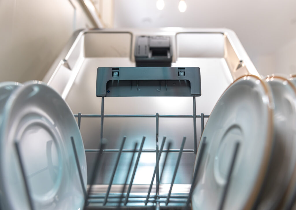 Close up of open dishwasher with clean dishes.